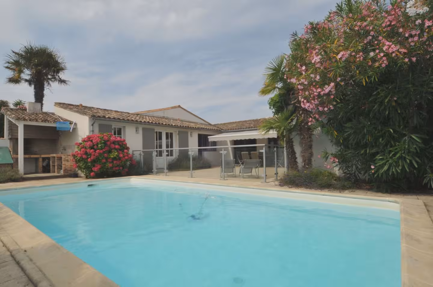 Private pool surrounded by tropical planting at the Rétais house in La Noue